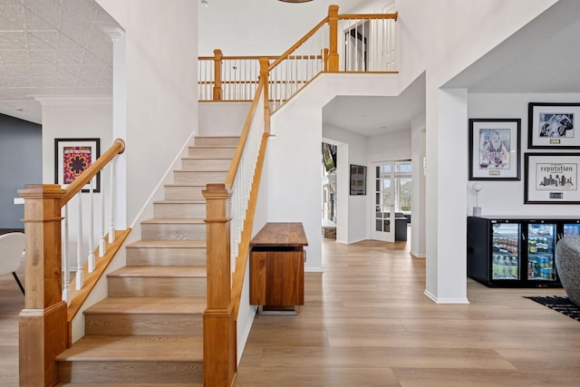 330 Lythrum Ln, Medina, MN 55340 - stairs with wood finished floors, baseboards, and a high ceiling