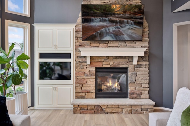 330 Lythrum Ln, Medina, MN 55340 - living room featuring wood finished floors and a stone fireplace