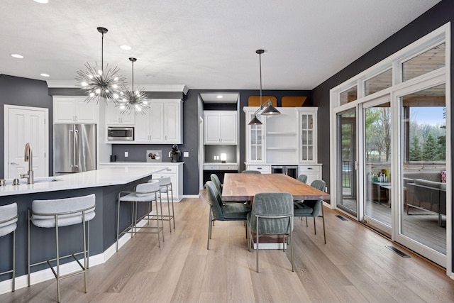 330 Lythrum Ln, Medina, MN 55340 - dining area featuring light wood-type flooring, a chandelier, recessed lighting, and baseboards