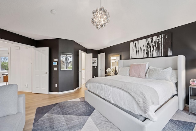 330 Lythrum Ln, Medina, MN 55340 - bedroom featuring light wood-style flooring, baseboards, and a chandelier