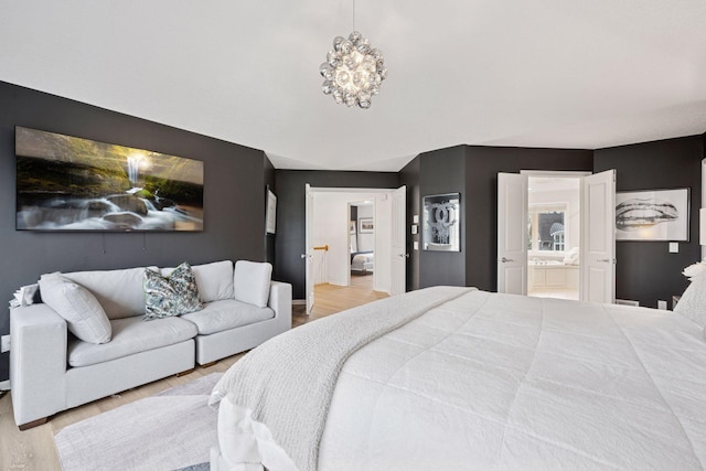 330 Lythrum Ln, Medina, MN 55340 - bedroom featuring light wood finished floors, connected bathroom, baseboards, and a chandelier