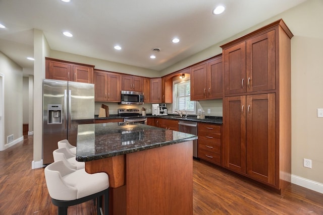 67457 152nd Ave, Greenfield Twp, MN 55981 - kitchen with stainless steel appliances, baseboards, a center island, recessed lighting, and dark wood-style flooring