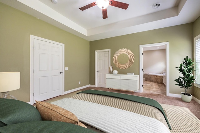 67457 152nd Ave, Greenfield Twp, MN 55981 - carpeted bedroom with baseboards, ensuite bath, a raised ceiling, and a ceiling fan