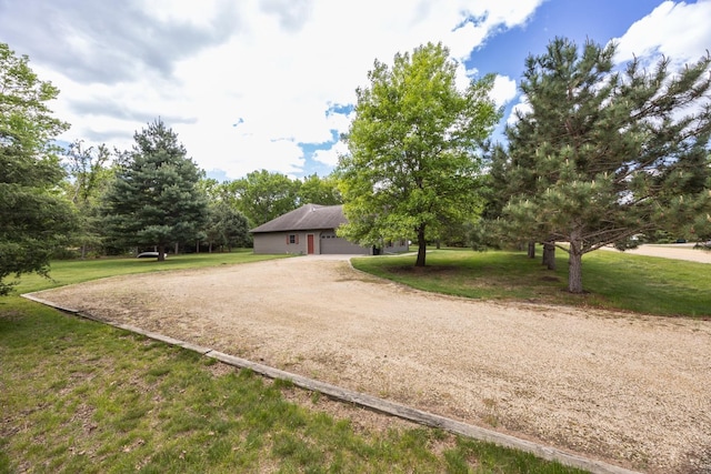 67457 152nd Ave, Greenfield Twp, MN 55981 - view of front of property featuring dirt driveway, a front yard, and a garage