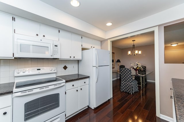 2051 Carriage Dr SW Unit 2051A, Rochester, MN 55902 - kitchen featuring white appliances, dark countertops, dark wood-style flooring, a chandelier, and recessed lighting