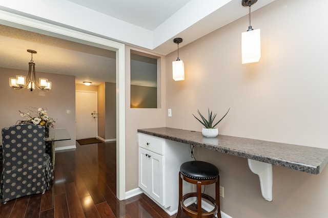 2051 Carriage Dr SW Unit 2051A, Rochester, MN 55902 - kitchen with baseboards, white cabinetry, dark countertops, and hanging light fixtures