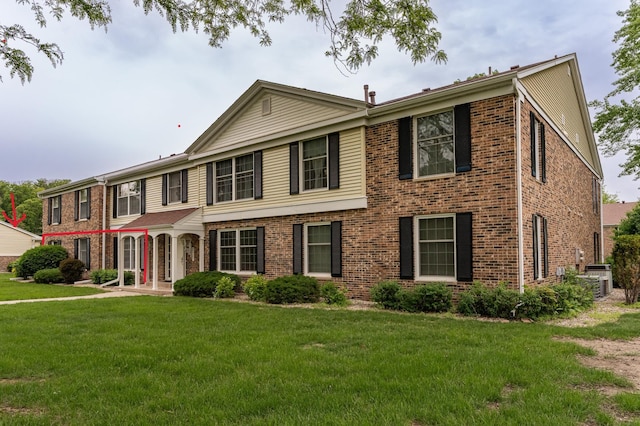 2051 Carriage Dr SW Unit 2051A, Rochester, MN 55902 - view of front of property featuring brick siding, a front lawn, and central air condition unit