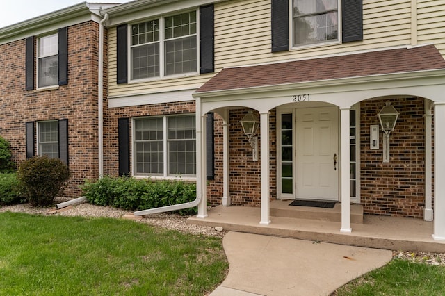 2051 Carriage Dr SW Unit 2051A, Rochester, MN 55902 - view of exterior entry featuring brick siding and roof with shingles