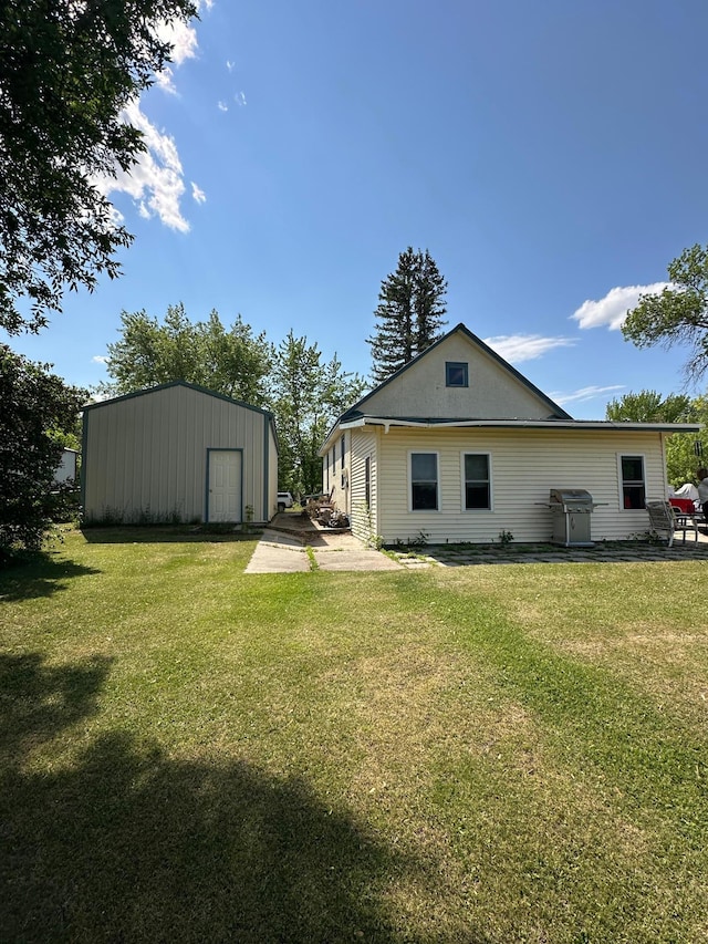 502 1st Ave SE, Baudette, MN 56623 - back of property with an outdoor structure and a lawn