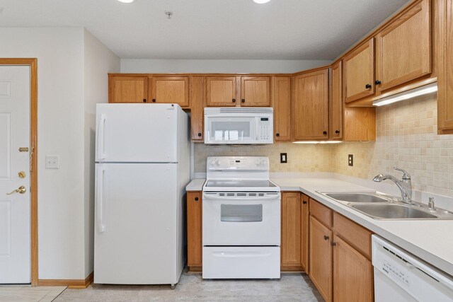 2231 Penn Pl Unit 224, North Saint Paul, MN 55109 - kitchen featuring white appliances, a sink, backsplash, and light countertops