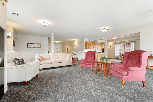 2231 Penn Pl Unit 224, North Saint Paul, MN 55109 - carpeted living room with wainscoting and a decorative wall