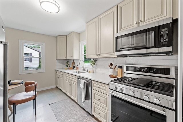 713 83rd Ave NE, Spring Lake Park, MN 55432 - kitchen featuring appliances with stainless steel finishes, a sink, plenty of natural light, and backsplash