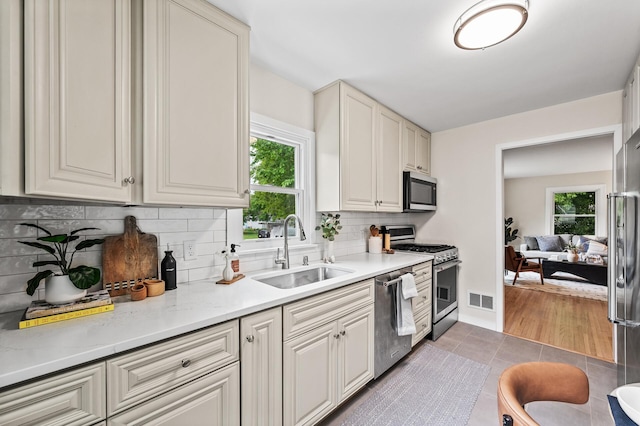 713 83rd Ave NE, Spring Lake Park, MN 55432 - kitchen featuring appliances with stainless steel finishes, a sink, healthy amount of natural light, and tile patterned floors