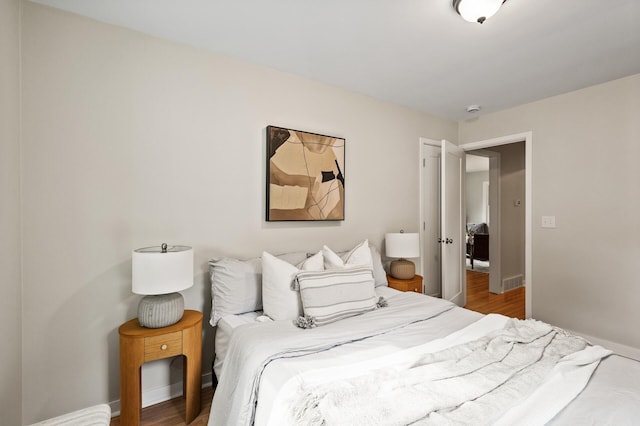 713 83rd Ave NE, Spring Lake Park, MN 55432 - bedroom featuring baseboards and wood finished floors