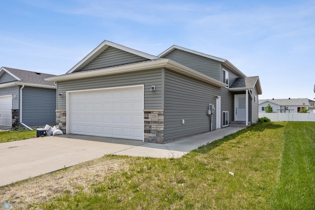 2128 Admiral Dr W, West Fargo, ND 58078 - view of side of home with an attached garage, stone siding, and concrete driveway