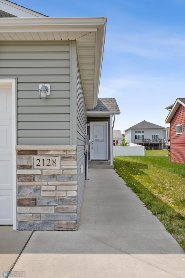 2128 Admiral Dr W, West Fargo, ND 58078 - view of exterior entry featuring a yard