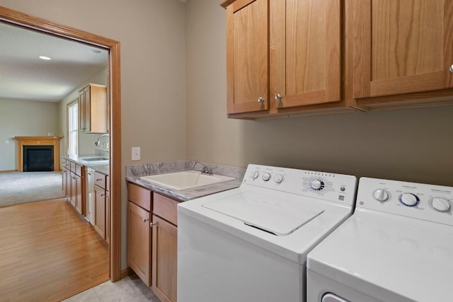 1223 Cypress Dr W, Annandale, MN 55302 - washroom featuring washer and clothes dryer, a fireplace, and cabinet space