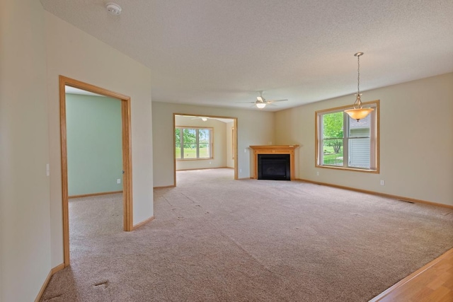 1223 Cypress Dr W, Annandale, MN 55302 - unfurnished living room featuring ceiling fan, baseboards, carpet, and a textured ceiling