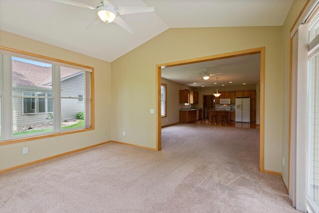 1223 Cypress Dr W, Annandale, MN 55302 - unfurnished living room featuring ceiling fan, light carpet, healthy amount of natural light, lofted ceiling, and baseboards