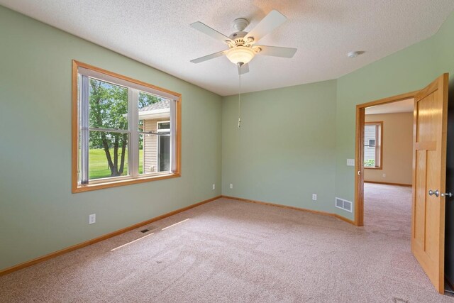 1223 Cypress Dr W, Annandale, MN 55302 - carpeted spare room featuring a textured ceiling, baseboards, ceiling fan, and a smoke detector