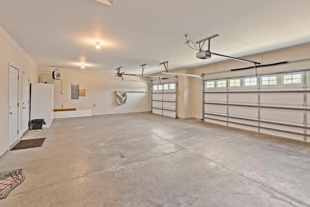 1223 Cypress Dr W, Annandale, MN 55302 - garage featuring electric panel and a garage door opener