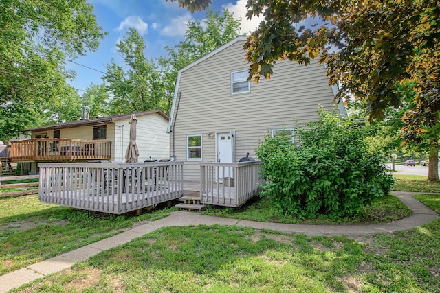 1221 11th St SE, Saint Cloud, MN 56304 - rear view of house with a yard and a wooden deck