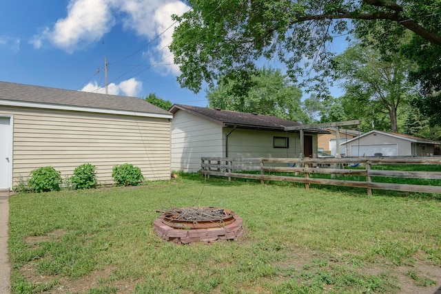 1221 11th St SE, Saint Cloud, MN 56304 - view of yard with an outdoor fire pit and a detached garage