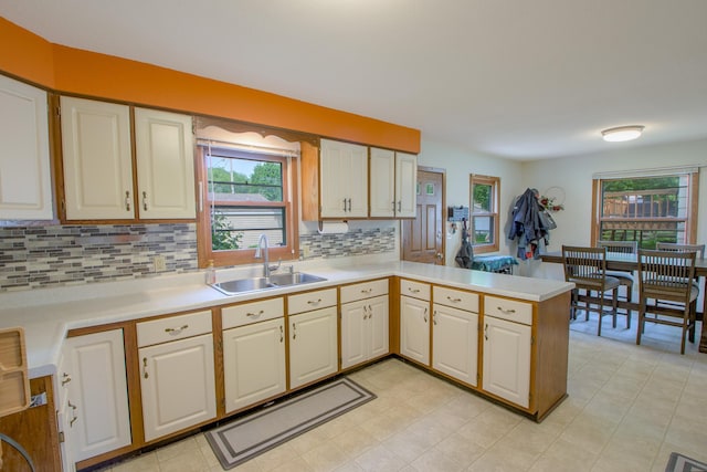 1221 11th St SE, Saint Cloud, MN 56304 - kitchen with a sink, light countertops, healthy amount of natural light, and a peninsula