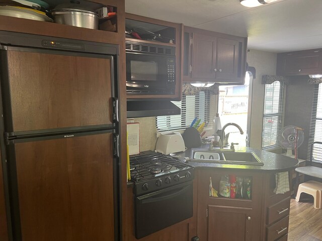 13240 Devils Lake Rd NW Unit 27And 26, Brandon Twp, MN 56315 - kitchen featuring black appliances, a sink, a peninsula, wood finished floors, and range hood