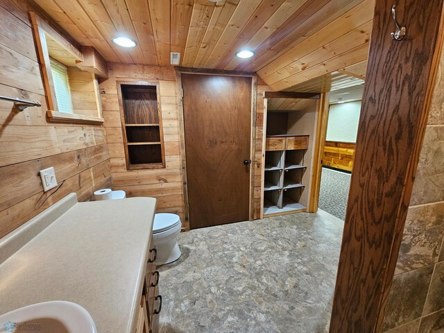609 1st St N, Wahpeton, ND 58075 - bathroom featuring wooden walls, wood ceiling, toilet, vanity, and recessed lighting