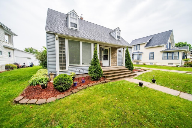 109 2nd St SW, Blooming Prairie, MN 55917 - cape cod house featuring a front yard, a shingled roof, covered porch, stone siding, and a chimney