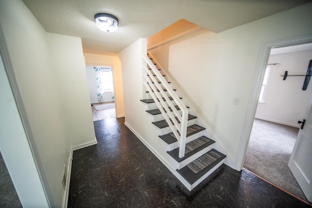 109 2nd St SW, Blooming Prairie, MN 55917 - stairs featuring baseboards and a textured ceiling