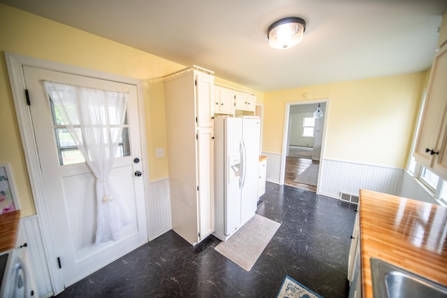 109 2nd St SW, Blooming Prairie, MN 55917 - foyer featuring wainscoting and dark flooring