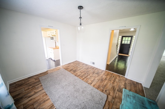 109 2nd St SW, Blooming Prairie, MN 55917 - unfurnished dining area with wood finished floors and baseboards