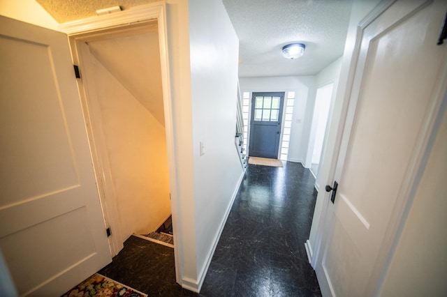 109 2nd St SW, Blooming Prairie, MN 55917 - corridor featuring a textured ceiling, baseboards, and stairs