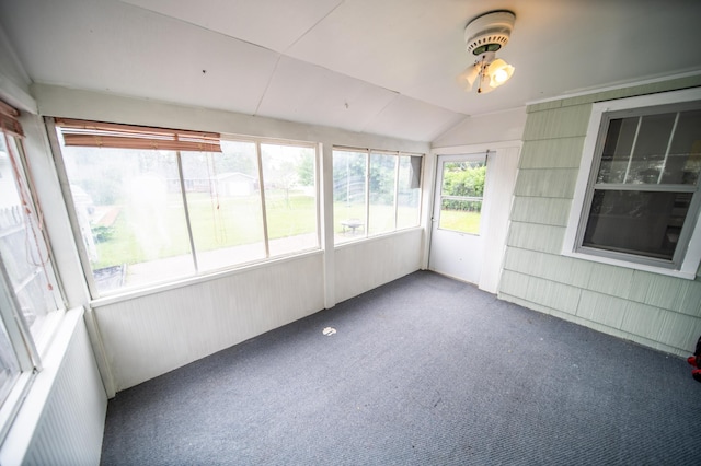 109 2nd St SW, Blooming Prairie, MN 55917 - unfurnished sunroom featuring carpet floors, vaulted ceiling, and ceiling fan