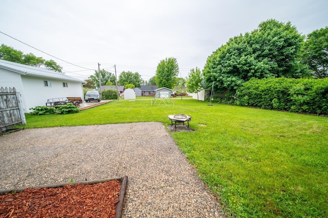 109 2nd St SW, Blooming Prairie, MN 55917 - view of grassy yard featuring an outdoor fire pit