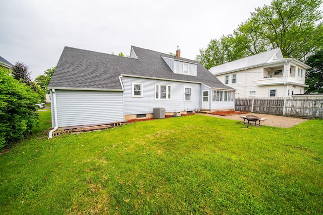 109 2nd St SW, Blooming Prairie, MN 55917 - rear view of house with an outdoor fire pit, central AC, roof with shingles, and a chimney