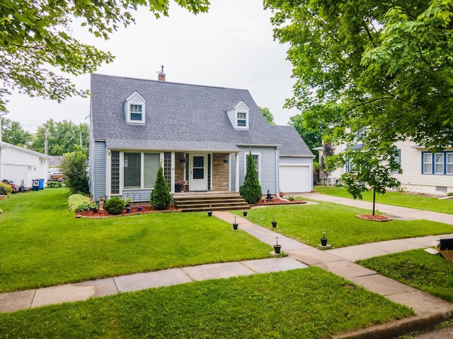 109 2nd St SW, Blooming Prairie, MN 55917 - cape cod-style house featuring a porch, a front yard, roof with shingles, concrete driveway, and a chimney