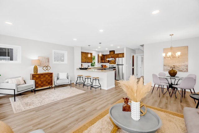 729 Burr St N, Saint Paul, MN 55130 - living area featuring light wood finished floors, a chandelier, and recessed lighting