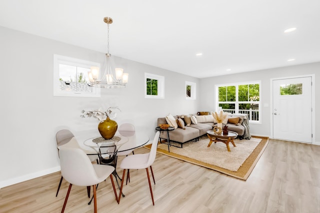 729 Burr St N, Saint Paul, MN 55130 - dining area with wood finished floors, a chandelier, recessed lighting, and baseboards