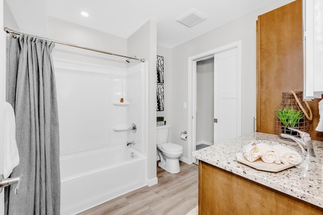 729 Burr St N, Saint Paul, MN 55130 - full bath with shower / bath combo, toilet, vanity, wood finished floors, and baseboards
