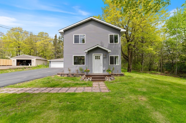 331 Locust St, Duluth, MN 55811 - traditional-style home with an outdoor structure, a front lawn, and a detached garage