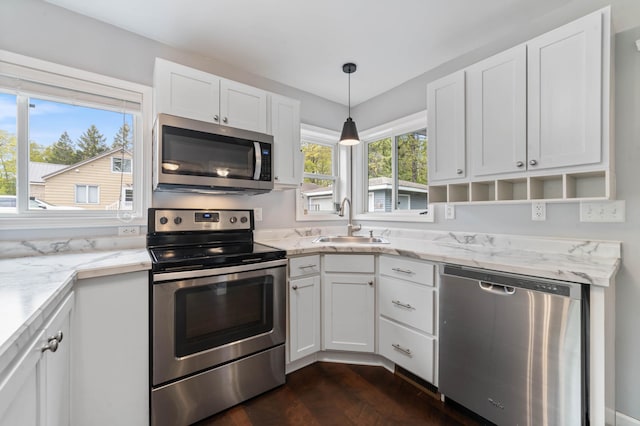 331 Locust St, Duluth, MN 55811 - kitchen with stainless steel appliances, a sink, white cabinetry, dark wood-style floors, and light stone counters