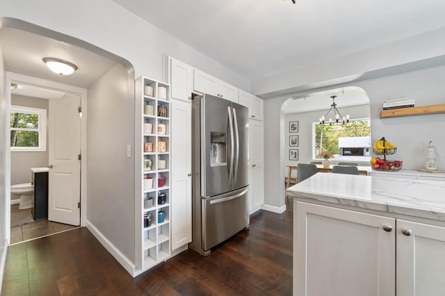 331 Locust St, Duluth, MN 55811 - kitchen featuring stainless steel refrigerator with ice dispenser, open shelves, arched walkways, white cabinetry, and baseboards