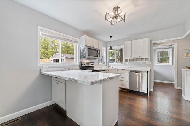 331 Locust St, Duluth, MN 55811 - kitchen with appliances with stainless steel finishes, a peninsula, white cabinetry, baseboards, and dark wood-type flooring