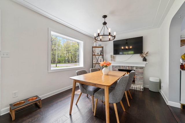 331 Locust St, Duluth, MN 55811 - dining room featuring a chandelier, baseboards, hardwood / wood-style flooring, and arched walkways