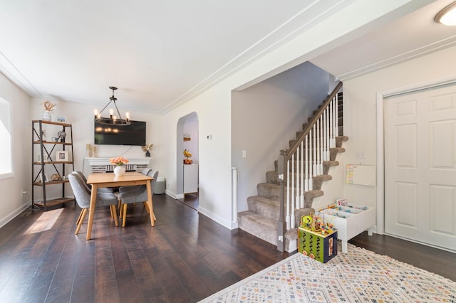 331 Locust St, Duluth, MN 55811 - dining area with arched walkways, stairway, dark wood-type flooring, baseboards, and a chandelier