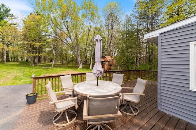 331 Locust St, Duluth, MN 55811 - wooden terrace with outdoor dining space, a lawn, and view of scattered trees