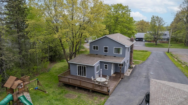 331 Locust St, Duluth, MN 55811 - back of house with a wooden deck, a shingled roof, a playground, driveway, and a yard